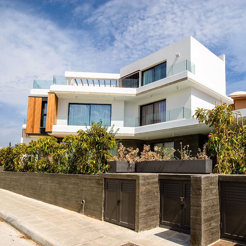 Modern two-storey home with large windows, timber accents, and landscaped garden—ideal for Mortgage Broker Gold Coast clients.