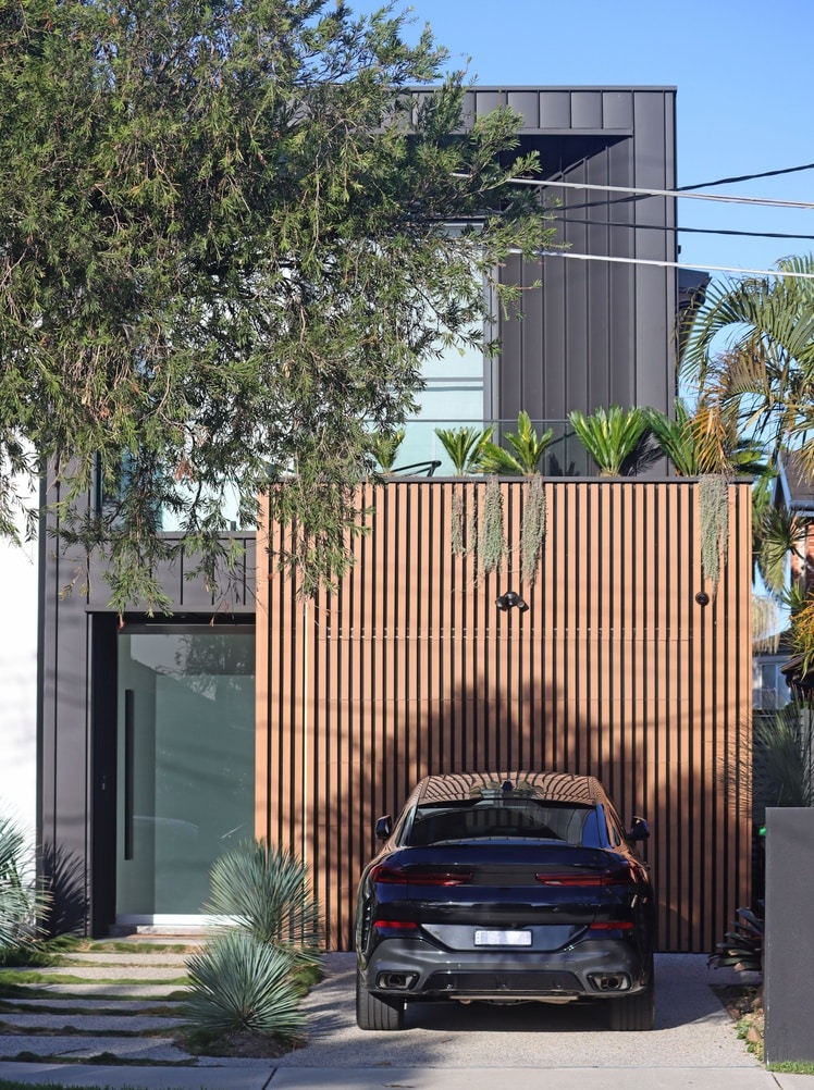 Modern two-storey house with wooden slats, large windows, and black car—ideal for Mortgage Broker Gold Coast clients.