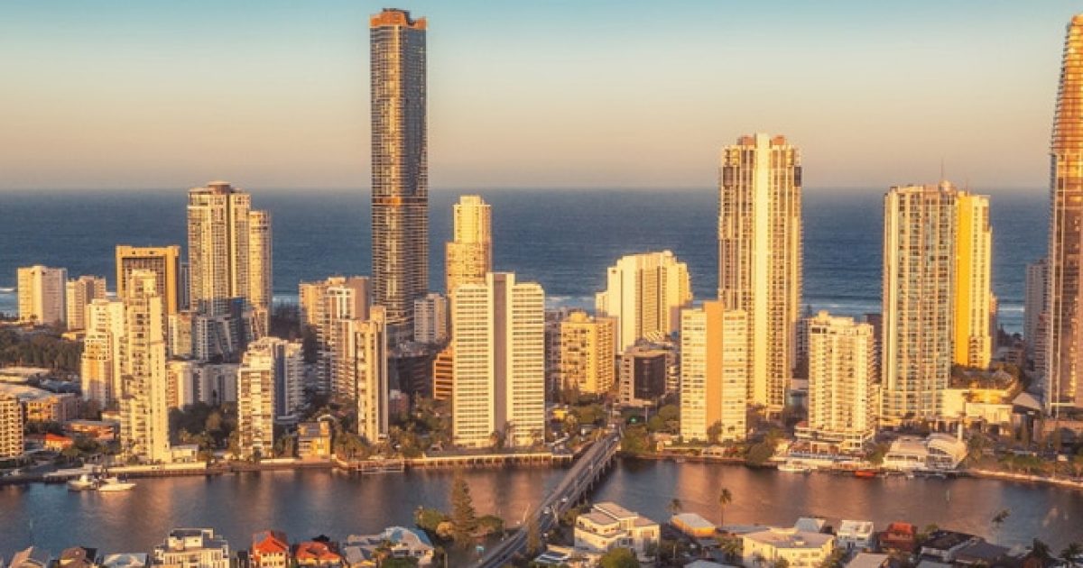 Mortgage Broker Gold Coast 26 Aerial view of Gold Coast skyline with skyscrapers, riverside homes, and sunset sky—ideal for those seeking a mortgage adviser.